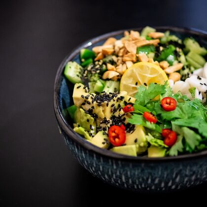 A photo of a vegan Buddha bowl on a dark background