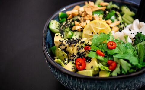 A photo of a vegan Buddha bowl on a dark background